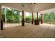 Spacious back porch showcasing wood floors, wooden pillars, railings, and scenic views at 690 Oaks Lane Rd, Timberlake, NC 27583