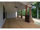 Expansive back porch featuring wood floors, a ceiling fan, wooden pillars and a view of surrounding greenery at 690 Oaks Lane Rd, Timberlake, NC 27583
