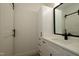 Bright bathroom featuring a white vanity, black hardware, a modern faucet and a framed mirror at 690 Oaks Lane Rd, Timberlake, NC 27583