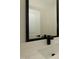 Bathroom close-up featuring a modern faucet, framed mirror, and a white counter and sink at 690 Oaks Lane Rd, Timberlake, NC 27583