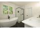 Elegant bathroom with a soaking tub, glass enclosed shower, and double sink vanity at 690 Oaks Lane Rd, Timberlake, NC 27583