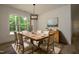 The dining room offers a rustic table with seating for eight, and a wooded view from the oversized window at 690 Oaks Lane Rd, Timberlake, NC 27583