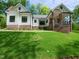 Charming home with brick accents, wood pillars and timber gable decoration on a manicured lawn and landscaping at 690 Oaks Lane Rd, Timberlake, NC 27583