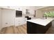 Beautiful kitchen with white cabinetry, stainless appliances, and an island with a white countertop at 690 Oaks Lane Rd, Timberlake, NC 27583