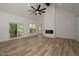 Bright living room with high ceilings, modern fireplace, light wood floors, and sliding doors at 690 Oaks Lane Rd, Timberlake, NC 27583