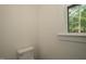 Neutral powder room with a window at 690 Oaks Lane Rd, Timberlake, NC 27583