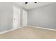 A cozy bedroom features neutral carpet, grey walls, and two white doors at 7924 Knightdale Blvd, Knightdale, NC 27545