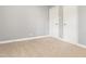 A simple bedroom offers carpet flooring and two doors at 7924 Knightdale Blvd, Knightdale, NC 27545