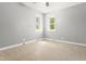 Sunlit bedroom with two windows provides a bright, airy space for comfort and relaxation at 7924 Knightdale Blvd, Knightdale, NC 27545
