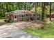 A charming brick ranch home is nestled among mature trees, creating a peaceful setting at 7924 Knightdale Blvd, Knightdale, NC 27545