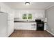 An updated kitchen with white cabinets and modern appliances creates a clean and efficient cooking space at 7924 Knightdale Blvd, Knightdale, NC 27545