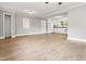 The bright, open floor plan living room features new floors and creates an inviting flow into the kitchen area at 7924 Knightdale Blvd, Knightdale, NC 27545