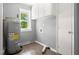 A well-lit utility room with new floors and ample cabinet space is perfect for laundry and storage at 7924 Knightdale Blvd, Knightdale, NC 27545