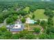 Community clubhouse with pool, tennis courts, golf course, and lush landscaping with mature trees at 8011 Old Trail Dr, Durham, NC 27712
