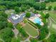 Aerial of community amenities featuring a clubhouse, pool, tennis courts, and beautifully landscaped grounds at 8011 Old Trail Dr, Durham, NC 27712