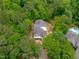 Aerial view of new home construction surrounded by lush green trees, in a private wooded setting at 8011 Old Trail Dr, Durham, NC 27712