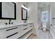 Sleek bathroom with double vanity, modern fixtures, and tiled floors at 8011 Old Trail Dr, Durham, NC 27712
