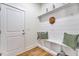 Organized mudroom with built-in bench, storage shelves, and shiplap wall at 8011 Old Trail Dr, Durham, NC 27712