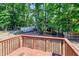 Relaxing backyard view from the deck surrounded by lush greenery and a storage shed at 100 Honeysuckle Ln, Cary, NC 27513