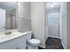 Bathroom with vanity, toilet, and walk-in shower, plus tile floors and natural light at 100 Honeysuckle Ln, Cary, NC 27513