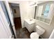 A well-lit bathroom featuring a vanity with sink, toilet, and storage, maximizing space and utility at 100 Honeysuckle Ln, Cary, NC 27513