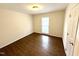 Bright bedroom with hardwood floors, white walls, and a window letting in natural light at 100 Honeysuckle Ln, Cary, NC 27513