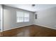 Bright bedroom featuring hardwood floors and a window for natural light at 100 Honeysuckle Ln, Cary, NC 27513