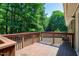 The outdoor deck is ideal for relaxing and features wood railing and nearby sliding doors at 100 Honeysuckle Ln, Cary, NC 27513