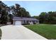 Charming single-story home with an attached garage, driveway, and well-maintained lawn at 100 Honeysuckle Ln, Cary, NC 27513
