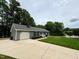 Charming single-story home with an attached garage, driveway, and a well-maintained lawn at 100 Honeysuckle Ln, Cary, NC 27513