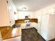 Bright kitchen with white cabinets and butcher block countertops, complemented by neutral flooring at 100 Honeysuckle Ln, Cary, NC 27513