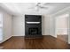 Open living room with dark brick fireplace and bright white trim at 100 Honeysuckle Ln, Cary, NC 27513