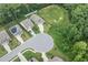 An aerial view of houses in a neighborhood with a green lawn and backyard at 100 Pronghorn Deer Ct, Garner, NC 27529