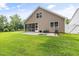 Spacious backyard featuring a patio, grill, and lush green lawn, perfect for outdoor entertaining at 100 Pronghorn Deer Ct, Garner, NC 27529