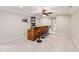 Entertainment area featuring a stylish bar with granite countertop, seating, and a ceiling fan at 100 Pronghorn Deer Ct, Garner, NC 27529