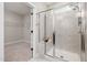 Glass shower and view into the walk-in closet in the modern bathroom at 100 Pronghorn Deer Ct, Garner, NC 27529