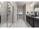 Modern bathroom featuring double vanity, glass shower, and tiled floors and walls at 100 Pronghorn Deer Ct, Garner, NC 27529