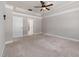 Neutral bedroom with carpeted floors, trey ceiling, ceiling fan, and walk-in closet at 100 Pronghorn Deer Ct, Garner, NC 27529
