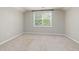 Bright bedroom with neutral carpeting and paint with a window providing natural light at 100 Pronghorn Deer Ct, Garner, NC 27529