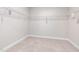 Walk-in closet featuring neutral carpet and wire shelving, offering ample storage space at 100 Pronghorn Deer Ct, Garner, NC 27529