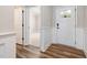 Inviting entryway with hardwood floors and wainscoting, leading to a brightly lit room at 100 Pronghorn Deer Ct, Garner, NC 27529