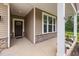 Welcoming covered front porch with stone accents and a view of the home's exterior at 100 Pronghorn Deer Ct, Garner, NC 27529