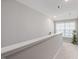 Bright hallway with neutral walls, carpet, and a window providing natural light at 100 Pronghorn Deer Ct, Garner, NC 27529