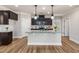 Kitchen island features granite countertops, pendant lights, and stainless steel appliances at 100 Pronghorn Deer Ct, Garner, NC 27529
