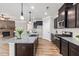 Kitchen with granite countertops, an island with pendant lighting, and stainless steel appliances at 100 Pronghorn Deer Ct, Garner, NC 27529