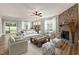 Beautiful living room featuring a stone fireplace, ceiling fan, and modern furniture at 100 Pronghorn Deer Ct, Garner, NC 27529