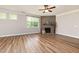 Comfortable living room features a stone fireplace, hardwood floors, and bright natural light at 100 Pronghorn Deer Ct, Garner, NC 27529