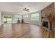 Spacious living room with hardwood floors, a stone fireplace, and sliding doors to the outside at 100 Pronghorn Deer Ct, Garner, NC 27529
