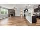 Spacious living area with stone fireplace, hardwood floors, and granite island in the kitchen at 100 Pronghorn Deer Ct, Garner, NC 27529
