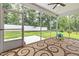 Inviting screened porch with outdoor seating, carpet, and view to backyard at 100 Pronghorn Deer Ct, Garner, NC 27529